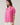 Mirany Ikat Bindy Puff Sleeve Top featuring pink ikat print, puff sleeves, and ruffle neckline.