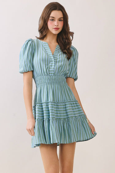 Striped Flattering V Slit Neck Bubble Sleeve Dress worn by model featuring a tiered ruffle skirt and smocked waist.