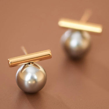 18K Gold Plated Waterproof Stainless Steel Stud Earrings 7743 displayed as a pair on a brown background