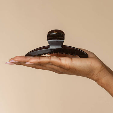 Large Arched Clip Black held in hand, showcasing eco-friendly design and durable construction.