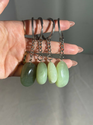 Burma Jade Crystal Keychain featuring polished green gemstones displayed in a hand
