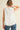 Back view of the Pleated throughout Sleeveless A Line Top featuring a keyhole closure and layered pleated hem.