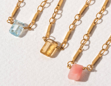 Prism Gems Birthstone Necklace - November with faceted gemstones in blue, yellow, and pink on a gold chain.