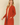 Shop Wall rust orange long sleeve open front cardigan with side pockets worn by a smiling blonde woman