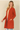 Shop Wall rust orange long sleeve open front cardigan with side pockets worn by a smiling blonde woman