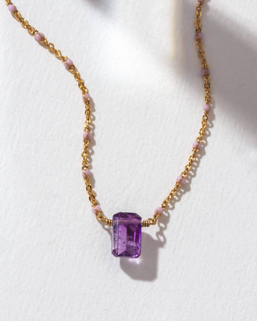 Prism Gems Birthstone Necklace - February featuring an amethyst stone on a gold and pastel chain.