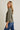Side view of model wearing olive green Round Neck 3-4 Sleeve Top