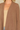 Shop Wall brown open front long sleeve cardigan with side pockets worn over a beige tank top