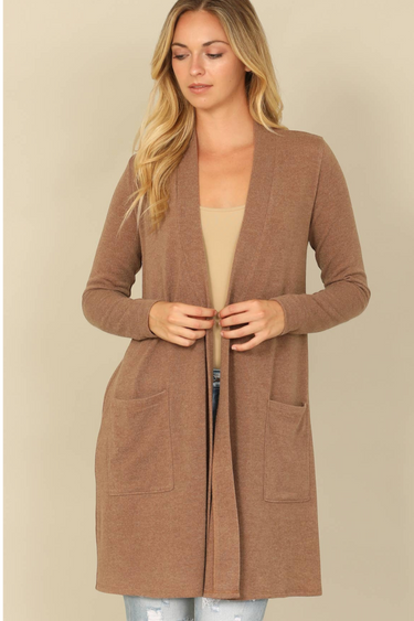 Shop Wall open front cardigan in brown with long sleeves and side pockets worn by a blonde model