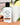 Spiced Apple Cider Goat Milk Lotion bottle displayed with apple cider and fresh apple slices.