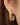18K Gold Plated Waterproof Stainless Steel Hoop Earrings 7376 worn on an ear showing the gold finish
