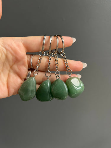 Green Aventurine Crystal Keychain featuring polished green gemstones displayed in a hand