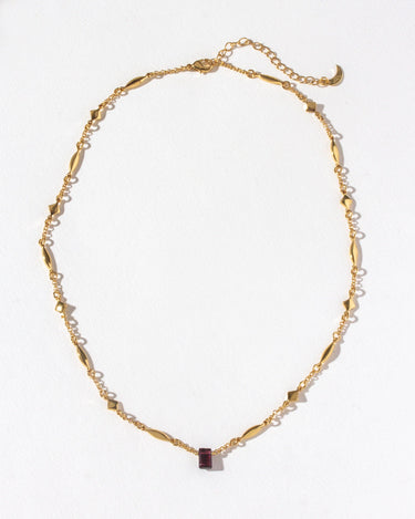 Prism Gems Birthstone Necklace - January featuring a garnet with a gold-plated starburst design and marquise chain.