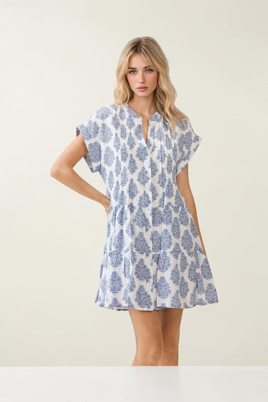 Model wearing a Printed Notch Neckline Tiered Mini Dress with short flutter sleeves and a tiered skirt.