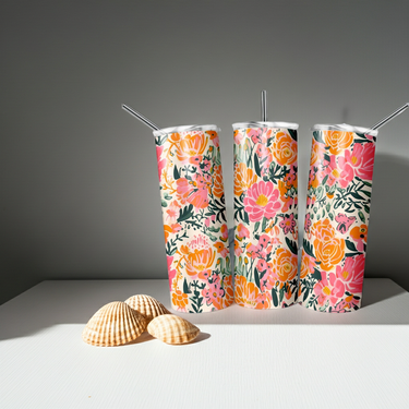 Floral Tumbler Flower Tumbler Preppy Tumbler trio with colorful floral designs and two seashells on a white surface.