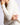 Close-up of model wearing Chiara white long-sleeve pullover sweater