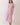 Model wearing a Pink Tropical Print Puff Sleeve Midi Dress with a V-neckline and puff sleeves.