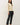 Side view of model wearing cream raglan sleeve slub pullover sweater