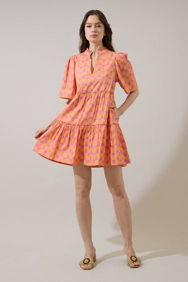 Model wearing the Dixie Split Neck Shift Dress Drift Floral in vibrant pinks with pockets and a split neckline.