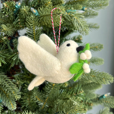 Dove with Olive Branch Felt Wool Christmas Ornament displayed among greenery