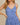 Model wearing SURPLICE S.P.G STRAP FALRE HEM DITSY MINI DRESS with floral design and adjustable straps.