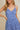 Model wearing SURPLICE S.P.G STRAP FALRE HEM DITSY MINI DRESS with floral design and adjustable straps.
