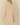 Back view of a woman wearing a Shop Wall beige long sleeve open front cardigan with a soft knit texture