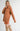 Side view of model wearing Elianna rust wide collar cardigan with shorts