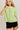 Model wearing green short sleeve sweater cardigan with black shorts