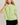 Model wearing green short sleeve sweater cardigan with black shorts