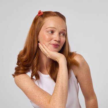 Model showcasing Recycled Mini Cloud Clips 8pc Set - Assorted Cherry Blossom in styled red hair.