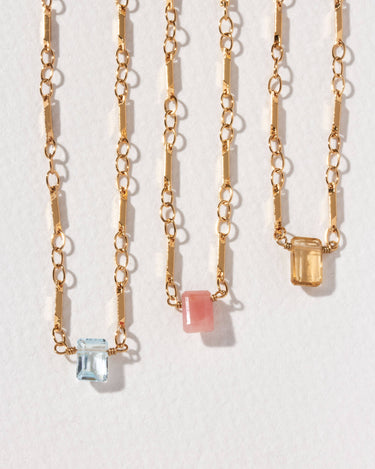 Prism Gems Birthstone Necklace - December featuring blue topaz and geometric link chain design.