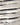 Close-up detail of gray striped round neck long sleeve sweater fabric