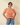Front view of model wearing orange Round Neck Puff Short Sleeve Cable Sweater with blue jeans