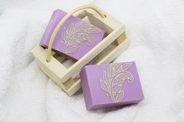 Organic Love Purple Handmade Soap in a wooden basket with decorative leaf designs.