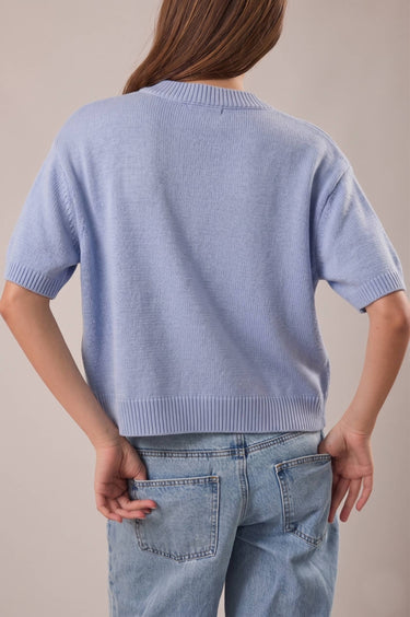 Back view of model wearing blue short sleeve sweater cardigan