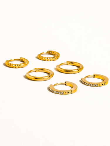 Set of six Claude 18K Gold Non-Tarnish CZ Hoops Earrings featuring various designs and cubic zirconia accents.