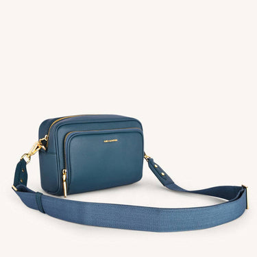 Mira & Moss Lucienne Crossbody Bag in navy blue vegan leather with gold-tone hardware.