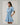 Gabriella Denim Fray Mini Dress styled with fringe details and cinched tie-waist, in lt denim color, featuring short sleeves and pockets.