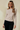 Boat neck semi bell long sleeve knit top in beige worn by model, showcasing a fitted silhouette and elegant design.