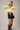Side view of model wearing yellow Round Rolled Hemline Detail Thin Sweater Cardigan