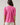 Back view of the Mirany Ikat Bindy Puff Sleeve Top with short puff sleeves and smocked cuffs in fuch red mul color.