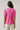 Back view of the Mirany Ikat Bindy Puff Sleeve Top with short puff sleeves and smocked cuffs in fuch red mul color.