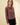 Side view of model wearing brown striped knit long sleeve button up cardigan with black pants