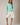 Model wearing mint green Round Rolled Hemline Detail Thin Sweater Cardigan with white shorts