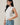 crew neck sleeveless diagonal panel stripe top angled front view