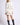 Chiara white long-sleeve pullover sweater on model, three-quarter back view
