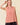 Striped Yoke Top in pink front view with black skirt