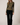 Full-length view of model wearing olive green Boat Neck Semi Bell Long Sleeve Knit Top with black pants