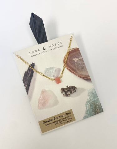 Prism Gems Birthstone Necklace - October displayed on card with pink Peruvian opal and gemstone backdrop.